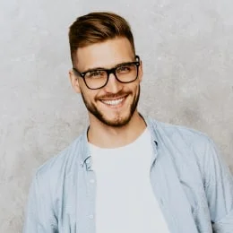 Smiling person wearing glasses and a casual shirt