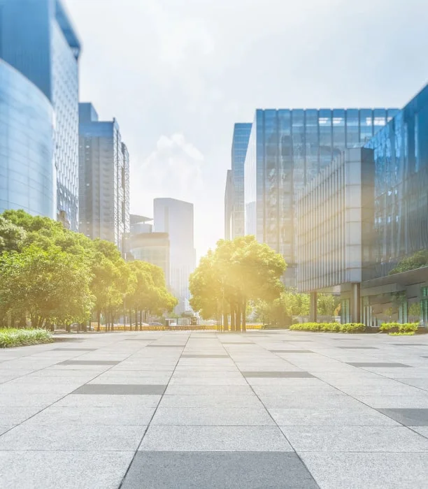Modern cityscape with sunlight and trees